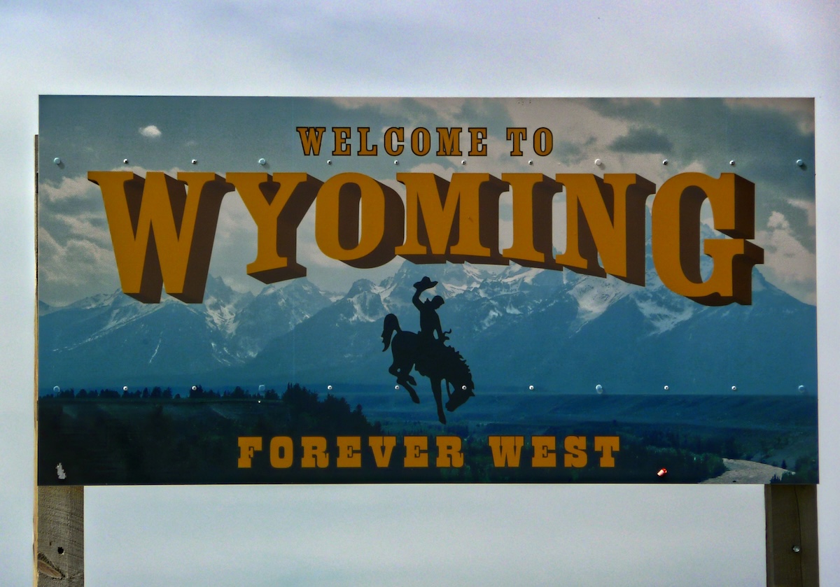A large billboard sign that reads, "Welcome to Wyoming: Forever West"